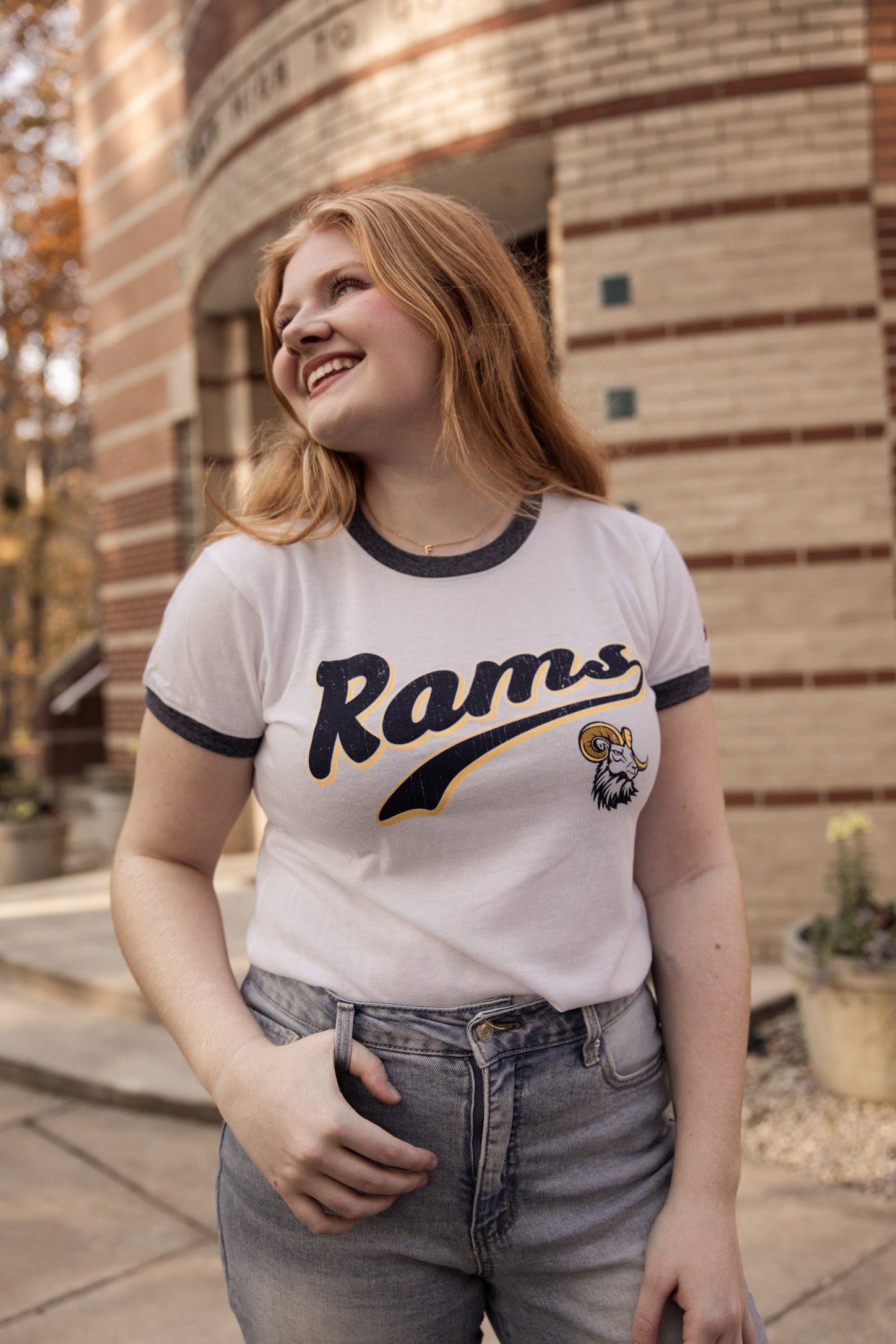Woman smiling and wearing a &